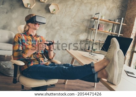 Photo portrait man in vr glasses checkered shirt playing video games with joystick after hard day Royalty-Free Stock Photo #2054471426
