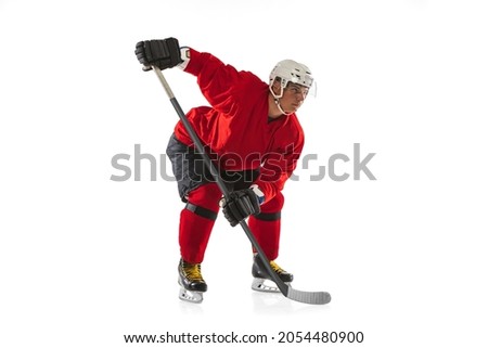 Full-length image of professional male hockey player training isolated over white background. Championship, competition, team game. High concentration. Concept of action, team sport game, energy, ad