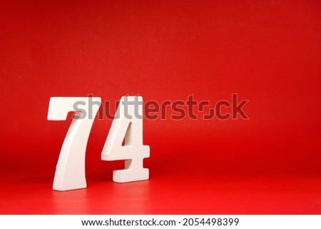 Seventy Four ( 74 ) white number wooden Isolated Red Background with Copy Space - New promotion 74% Percentage   Business finance or birthday Concept - advertise banner picture online with copy space