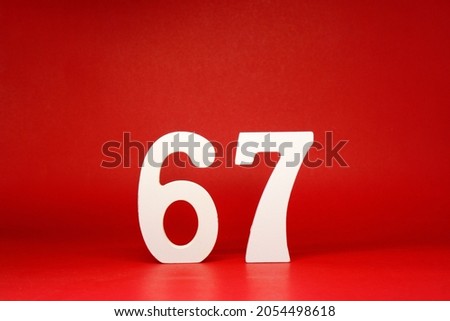Sixty Seven ( 67 ) white number wooden Isolated Red Background with Copy Space - New promotion 67% Percentage   Business finance or birthday Concept - advertise banner picture online with copy space