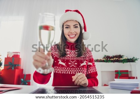 Photo of positive lady make clink wineglass web camera make wear santa hat sweater in decorated x-mas home indoors Royalty-Free Stock Photo #2054515235