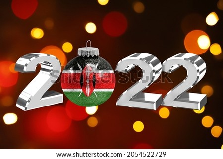 Colorful blurred background and applied the flag of Kenya on the New Year's toy. New Year 2022 Celebration