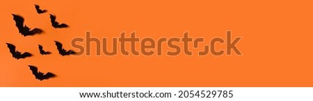 Halloween background. Bats on an orange background.Trick or treat. Banner. Copy space for text