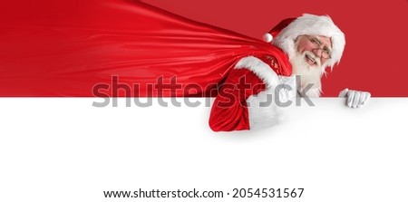 Xmas Santa Claus on whiteboard, holding sack on red background. Emotional senior male model old man with a natural white beard Father Christmas. Joyful character for advertising