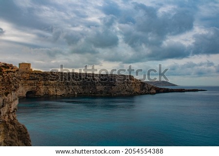 Comino Cliffs with Old Fortress and idyllic, blue Mediterranean Sea Royalty-Free Stock Photo #2054554388
