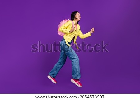 Full body profile side photo of young excited lady run hurry fast lesson rucksack isolated over violet color background