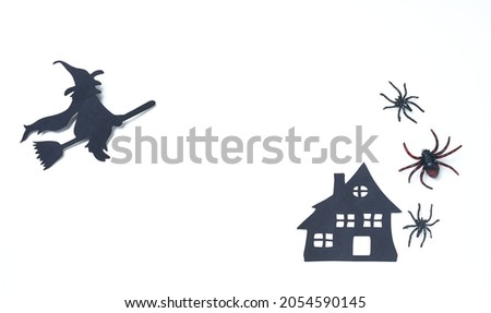 White and black Halloween decor with spiders, scary house and witch on broom. Banner or party invitation white background with objects. Place for text. Design for Web ads, promo sales, social media
