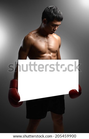 Competition sign with two red boxer gloves holding a blank white card as a business symbol of competitive sales or an important announcement day special isolated on white. 