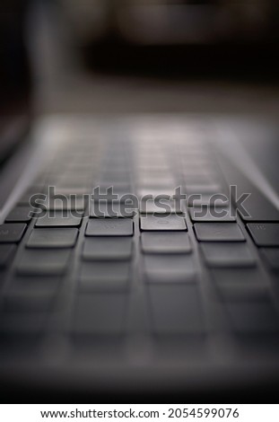 Space gray keyboard, dark background.