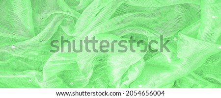 transparent green fabric with colored glitter, known for its library of classic and modern design. texture, background,