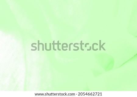 Green cloth. abstract background of luxury fabric or liquid silk texture of waves or wavy folds. background or elegant wallpaper design. Cotton texture, natural fabric and dye