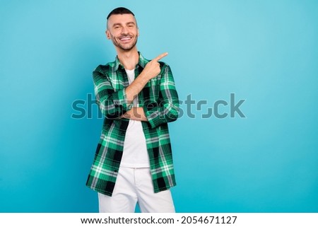 Photo portrait young man showing copyspace smiling isolated pastel blue color background