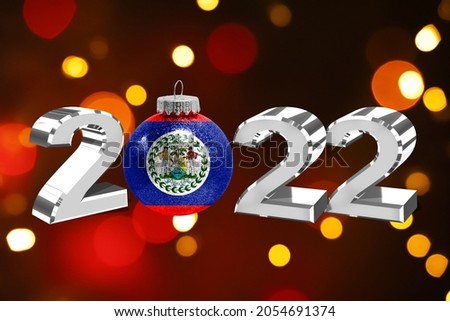 Colorful blurred background and applied the flag of Belize on the New Year's toy. New Year 2022 Celebration
