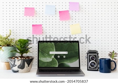 Blank laptop screen on a green workstation