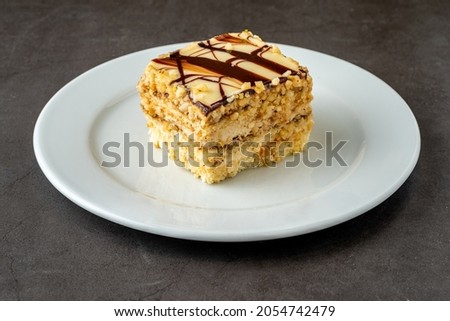 White chocolate and hazelnut cake on dark stone table