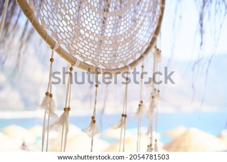 Dreamcatcher on the background of the sea on a turkish sandy beach Royalty-Free Stock Photo #2054781503