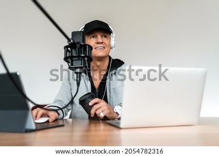 The man's favorite job is putting on music. The blogger works in a radio studio. The radio host transmits the news and speaks into the microphone. A freelancer puts on music for listeners.