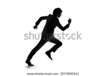 Silhouette of running young asian businessman. Royalty-Free Stock Photo #2054800661