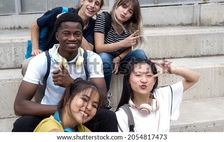POV of a group of smiling multi-ethnic teenage students taking a selfie. 