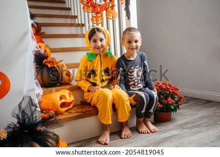 Cheerful siblings ready for halloween trick or treat