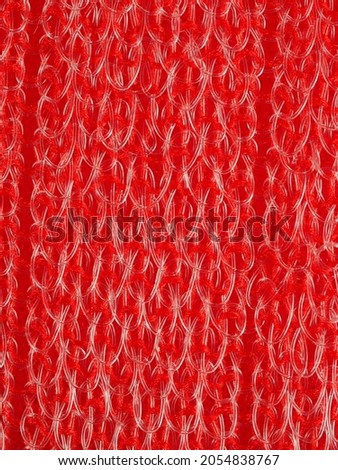 close up, background, texture, large vertical banner. heterogeneous surface structure bright saturated red sponge for washing dishes, kitchen, bath. full depth of field. high resolution photo