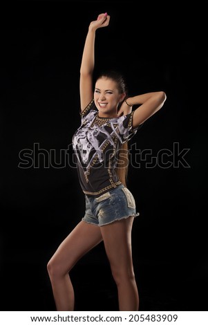 modern style dancer posing on studio, black background 