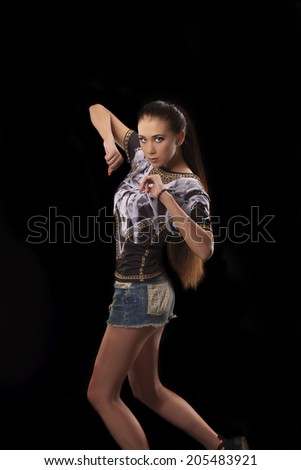 modern style dancer posing on studio, black background 
