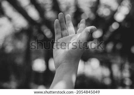 Hand in the air with an ethereal background