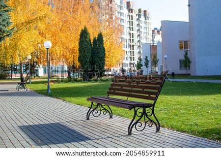  bench in autumn park under leaves