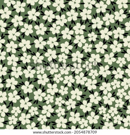 Seamless vintage pattern. cute white flowers and black leaves on a green background. vector texture. trend print for textiles, wallpaper and packaging.