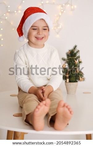 Little boy with Christmas tree on the white background. Happy child, Christmas celebration, Xmas time.