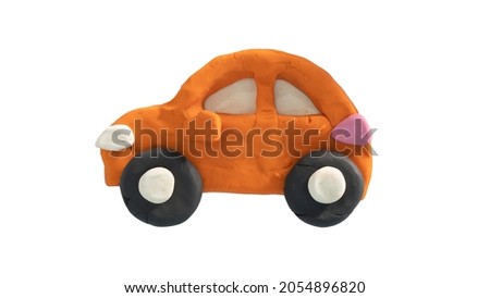 Beside view of car orange color. Made from plasticine. On isolated white background with clipping path.