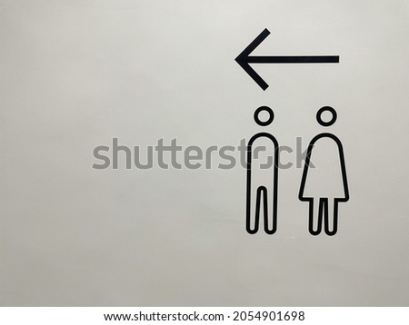 Signs pointing the way to the bathroom