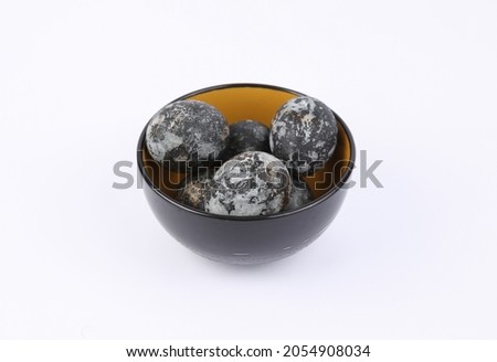 Gray marble painted Easter eggs in bowl on white background