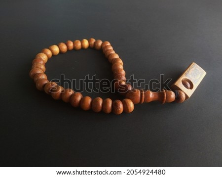 prayer beads made of wood on black background