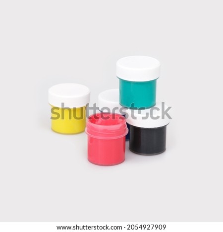 Bottles with multicolored gouache isolated on white background