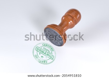 Green superior quality stamp with wooden rubber stamper isolated on white background with text certified 100% Organic .