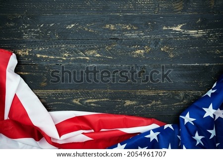 American flags on black wood background,image for 4th of july independence day Flag of USA on dark wooden wall texture background.
