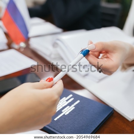Business meeting at the table, documents, hands, pens