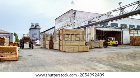 Work in an industrial warehouse. Forklift and tractor at industrial lumber warehouse Royalty-Free Stock Photo #2054992409