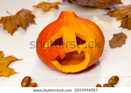 Lantern with pumpkin head for Halloween, with leaves on white