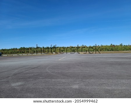 The large cement parking area at an airport. Royalty-Free Stock Photo #2054999462