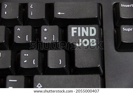 Closeup of a highlighted key on the keyboard of a laptop showing the word "find job"