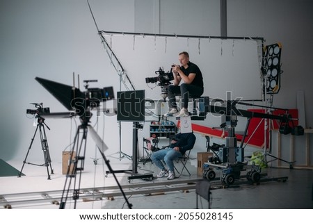 Film set, monitors and modern shooting equipment. Film crew, lighting devices, monitors, playbacks - filming equipment and a team of specialists in filming movies, advertising and TV series Royalty-Free Stock Photo #2055028145