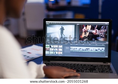 African american woman video editor working at creativity film montage sitting in modern agency office. Content creator in digital multimedia company processing movie with post production software