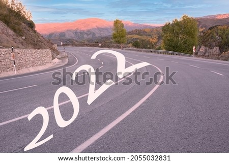 Start 2022 written on highway road in the middle of empty asphalt road and beautiful blue sky. Concept for vision new year 2022.
