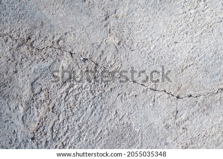 Cracks in concrete wall because it has an expiration date. Cracked cement wall background.