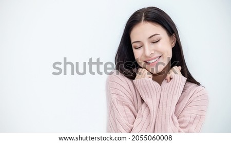 Portrait of young beautiful caucasian woman relax bedroom. Smile happy girl hands cover face wear winter cloth. Beauty treatment perfect clear skin white woman makeup winter hygge concept banner Royalty-Free Stock Photo #2055060008