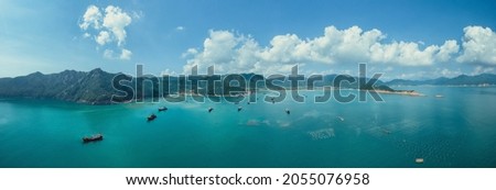 Aerial photography of blue sky and sea; a small  island in the sea