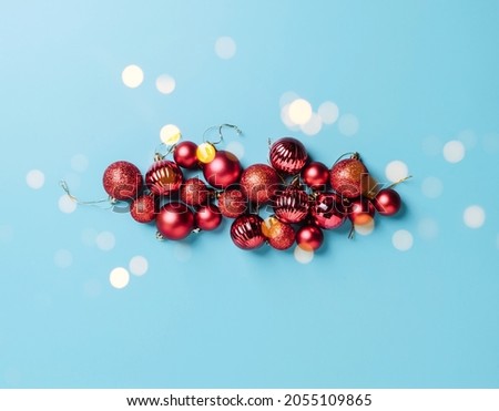 Christmas decorations red New Year's balls on blue background. Mock up holiday Christmas card copy space